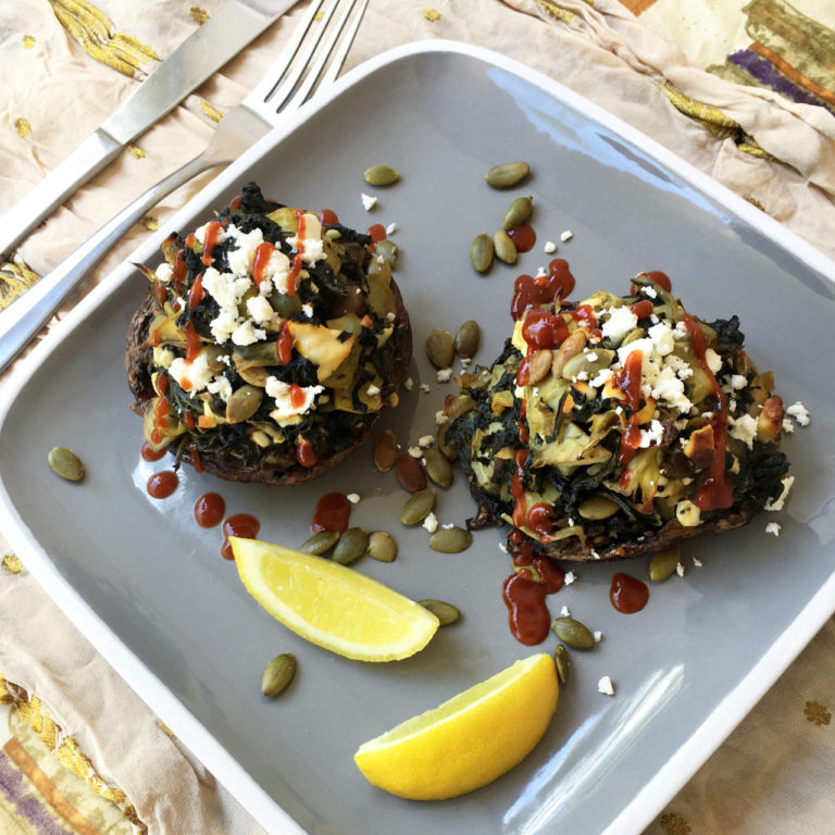 STUFFED PORTOBELLO MUSHROOMS WITH SPINACH, ARTICHOKES, FETA AND PEPITAS